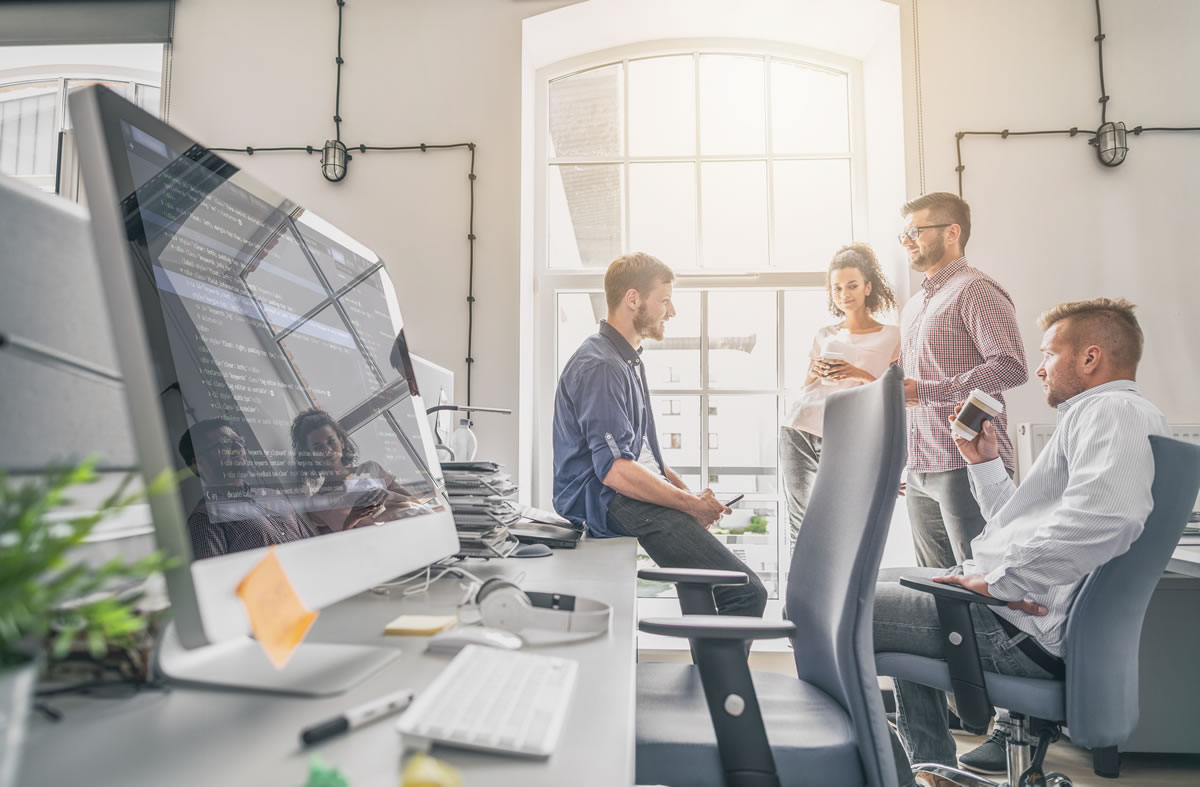 Young Business Professionals Next to Web Development Screen