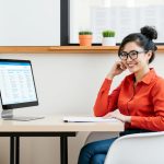 Woman sitting at table smiling