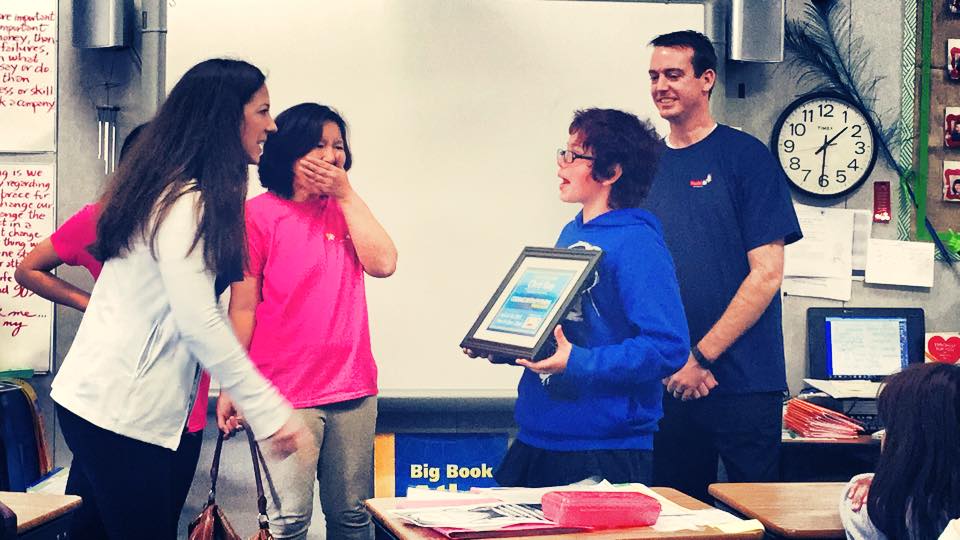 matt-morgan-presenting-scholarship-to-child
